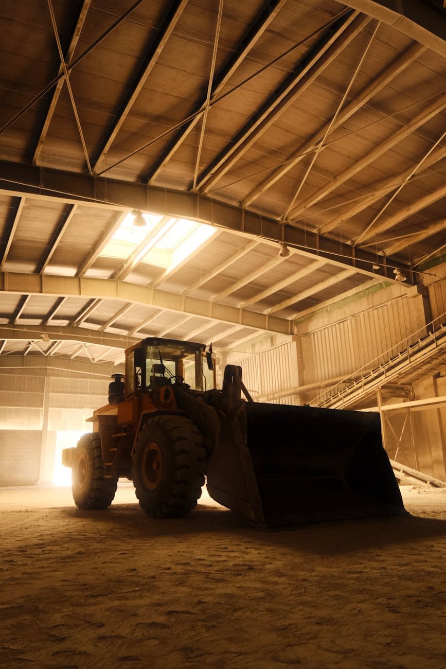 a large tractor is parked in a warehouse